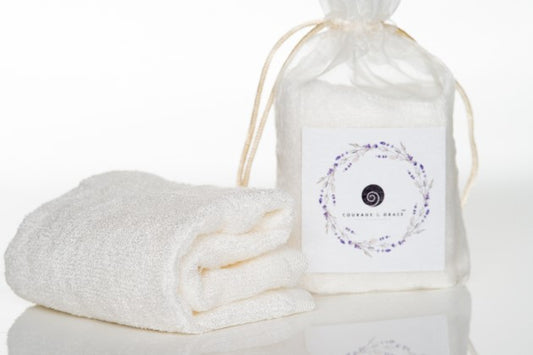 An image of Courage & Grace Body Care's cream colored organic bamboo washcloths for sensitive skin.
